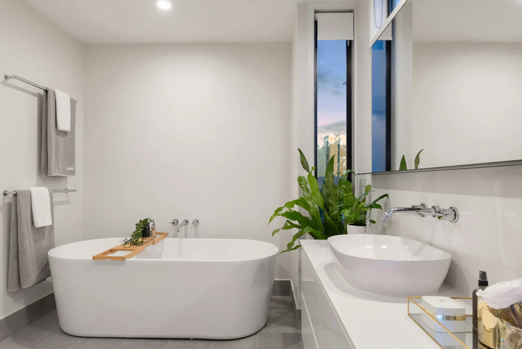 Remodeled Tampa Bay bathroom with marble tile and a double vanity by Artist Flooring & Showers
